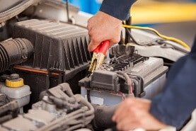 Fachmann prüft, ob die Autobatterie kaputt ist.